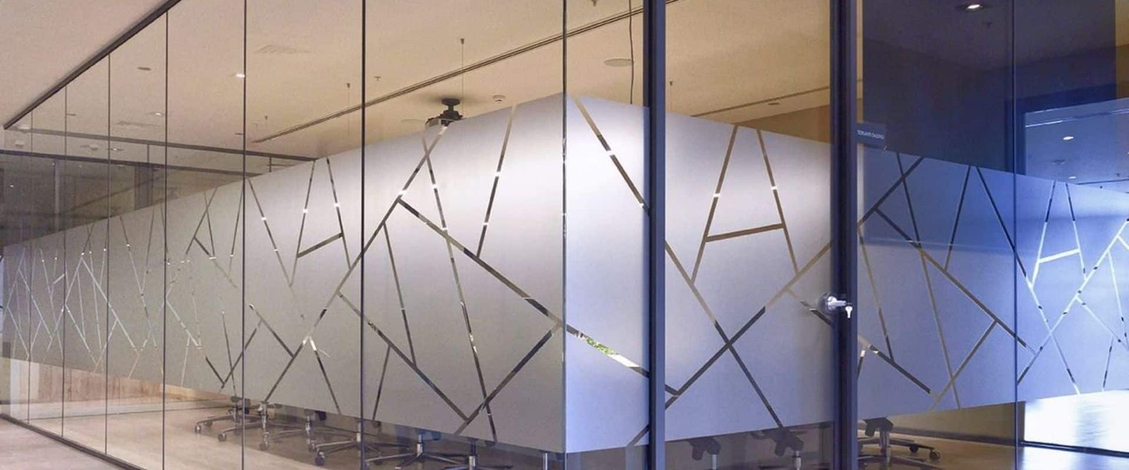 Custom frosted glass window film with geometric line design and professional branding